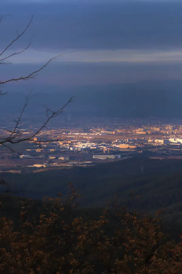 A city catching the last light, seen from the hills.