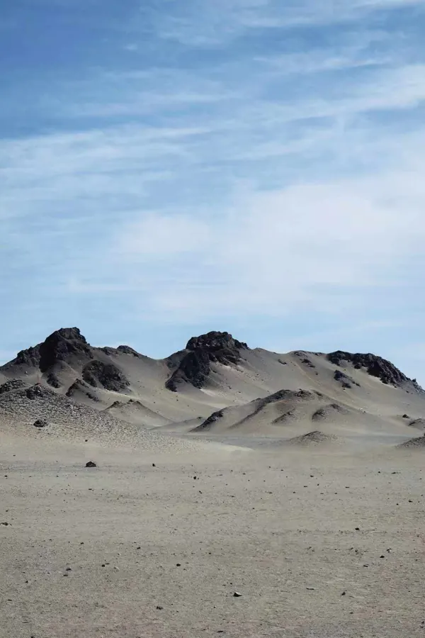Dark peaks above a pale desert.