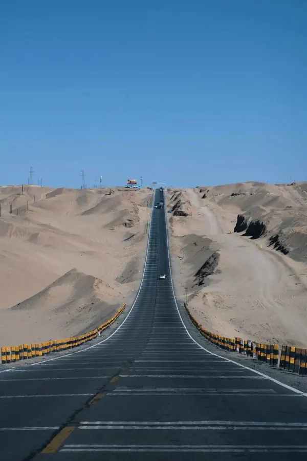 A straight road running through the dunes.
