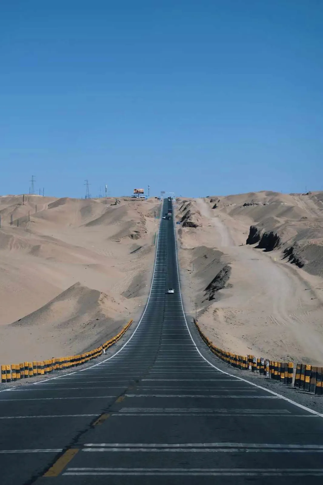 A straight road running through the dunes.