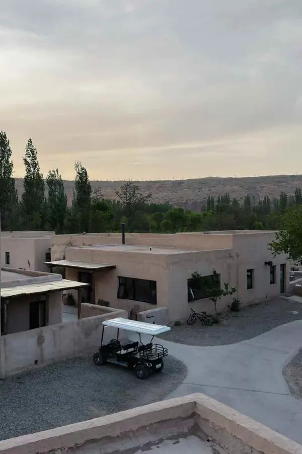 Earthen houses and a golf cart in a desert village.