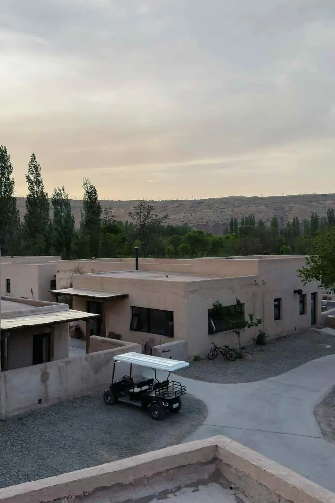 Earthen houses and a golf cart in a desert village.