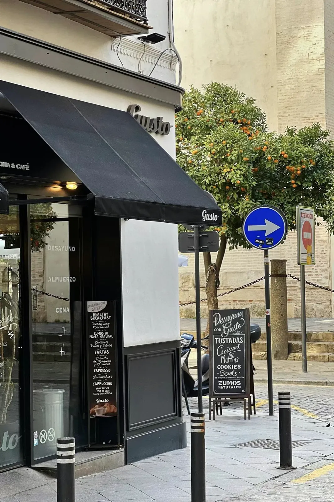 A corner café and an orange tree.