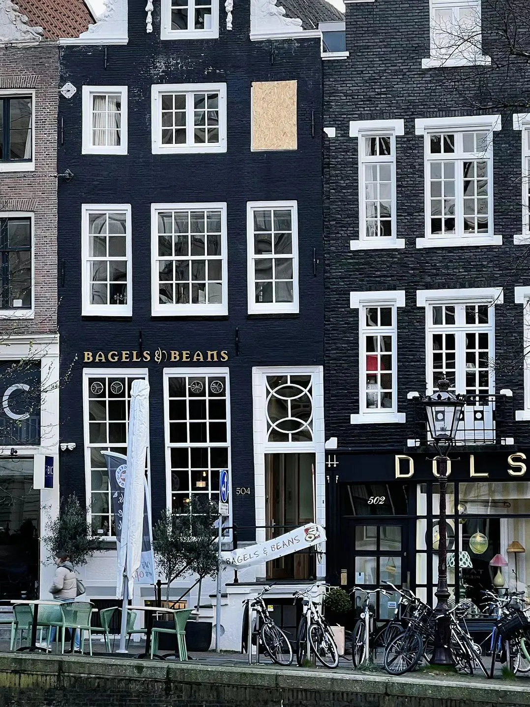 Narrow canal-house facades and bicycles.