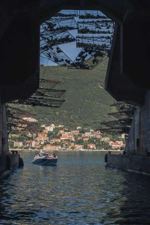 Looking out from a sea tunnel to a harbour town.
