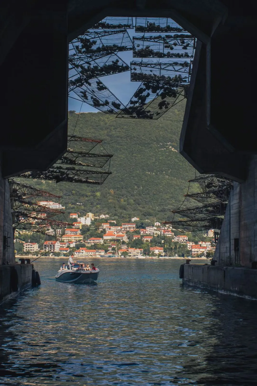 Looking out from a sea tunnel to a harbour town.