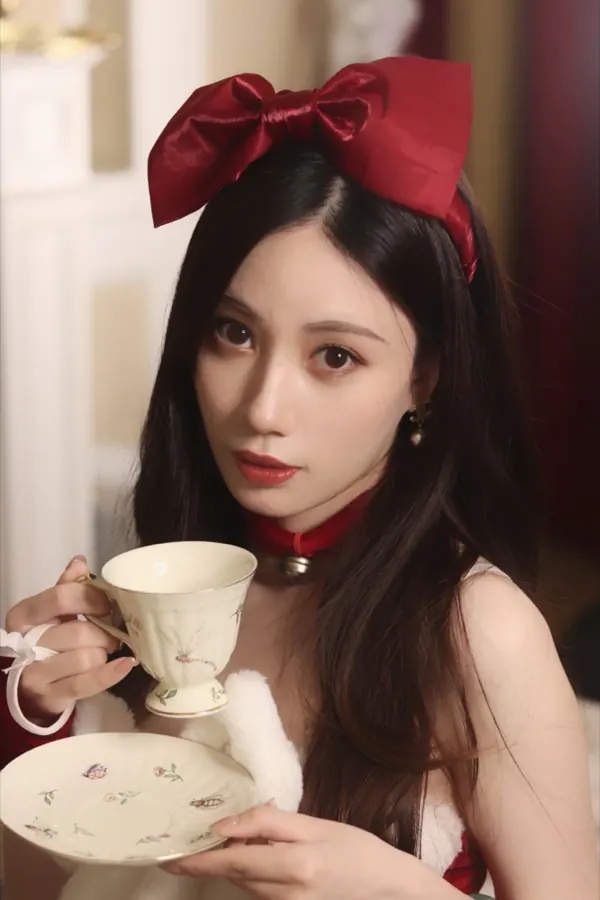 A red bow and a porcelain teacup.