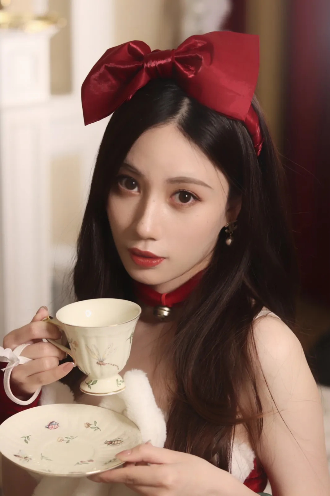 A red bow and a porcelain teacup.