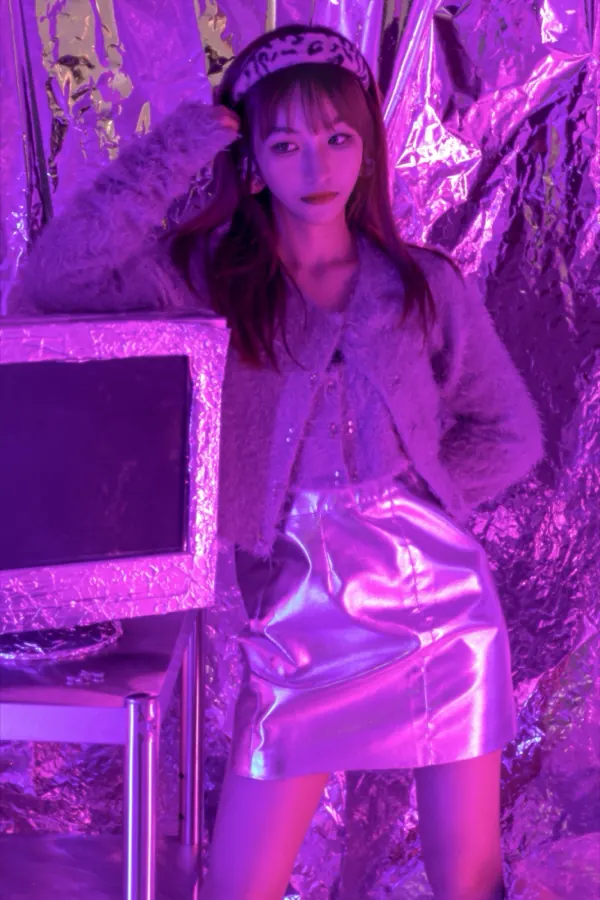 Purple neon on crumpled foil and a fluffy cardigan.